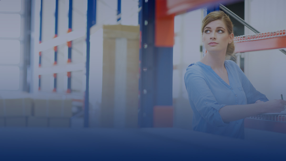 Woman in warehouse looking at her inventory